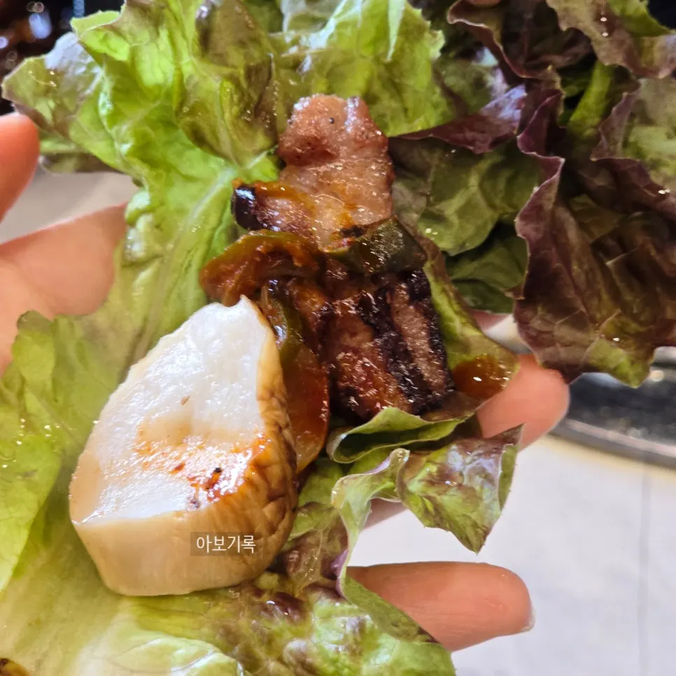 A bite combining mushroom and black pork meat together