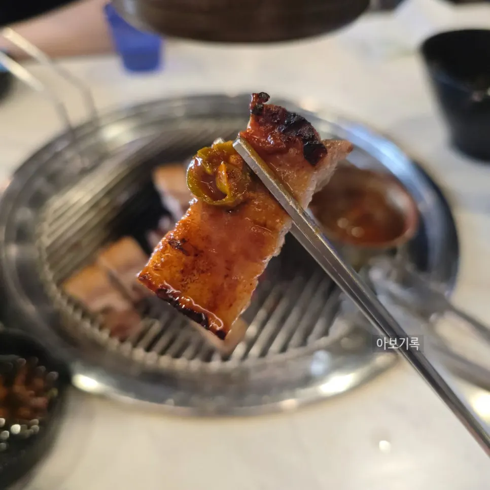 A piece of pork belly dipped in meljeot