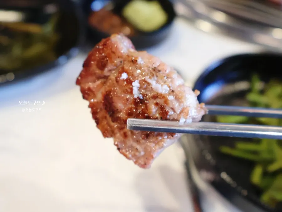 First bite of black pork neck dipped in salt