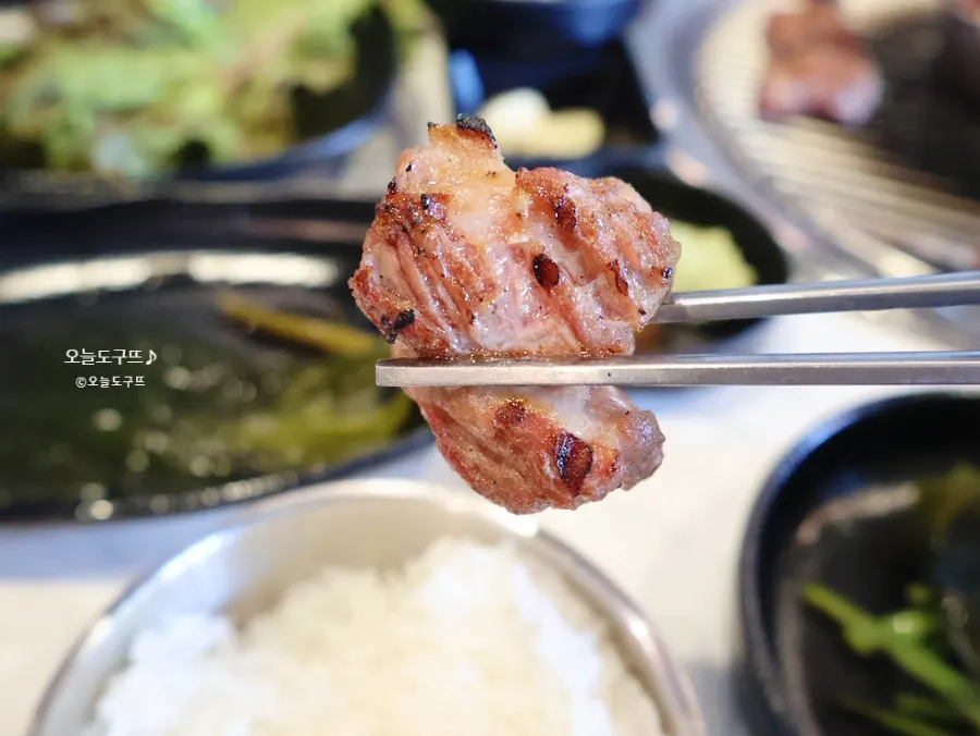 A piece of black pork neck eaten plain, no dip