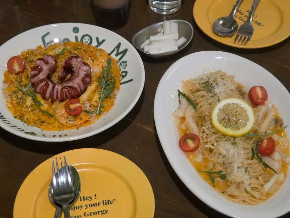 Two plates of pasta and risotto at Hey Joji