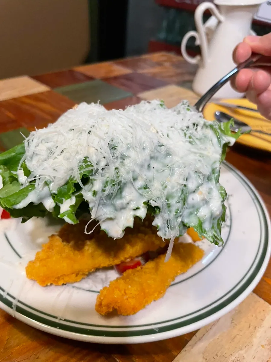 A plate of chicken tenders with vegetables