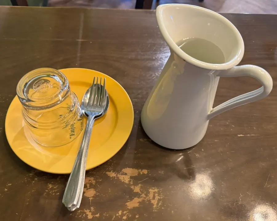 Basic table setting with dishes and water at Hey Joji