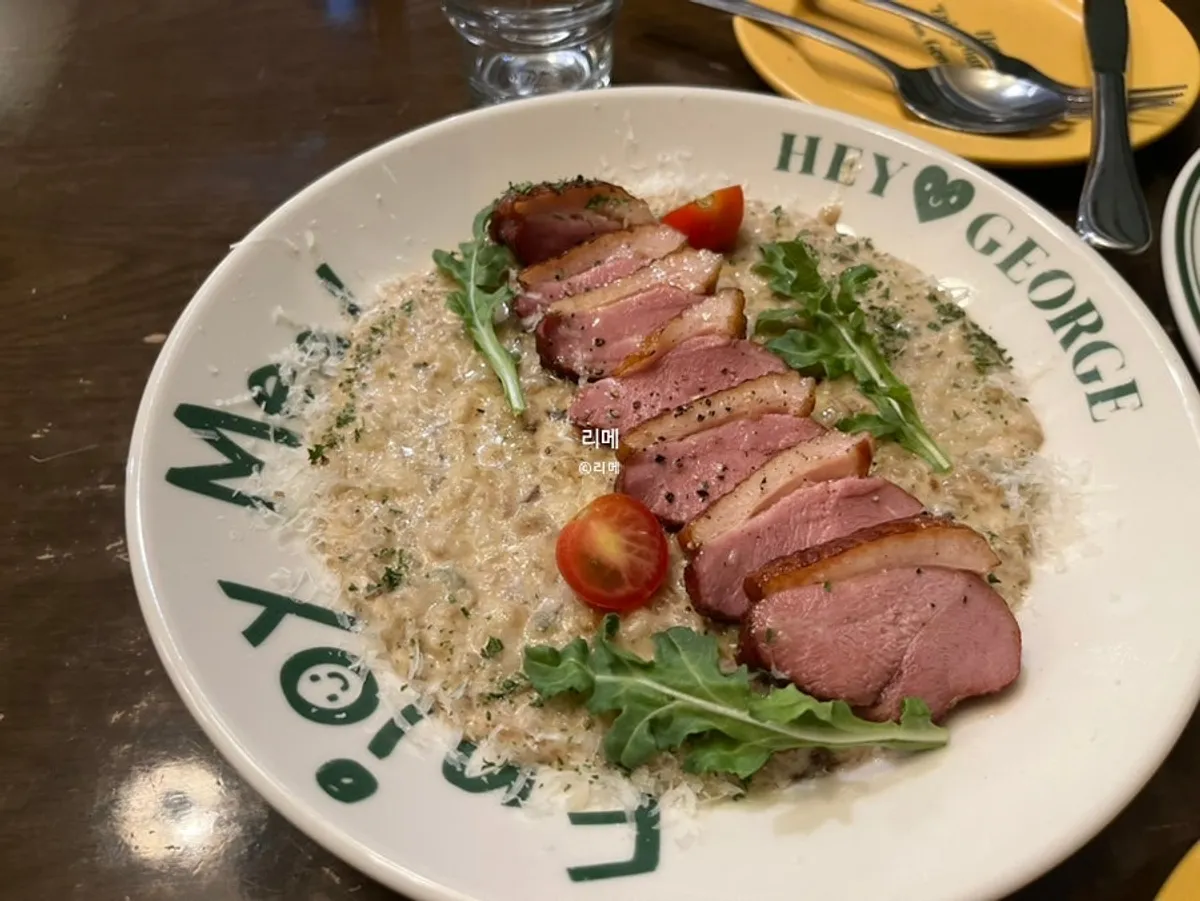Table setting with Hey Joji's duck steak risotto and chicken tender salad