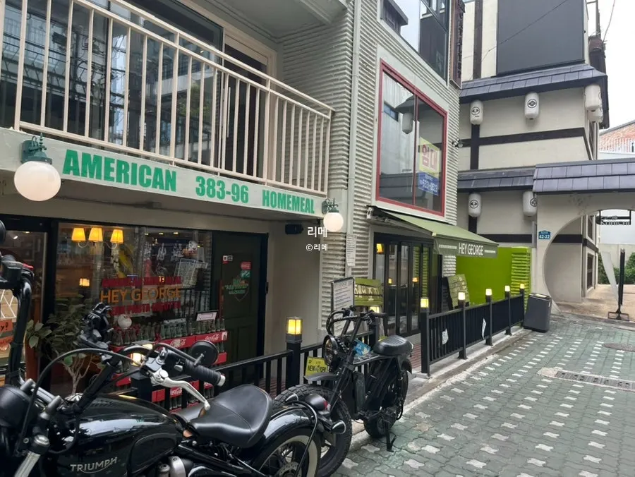 Hey Joji's green exterior visible at the end of the alley