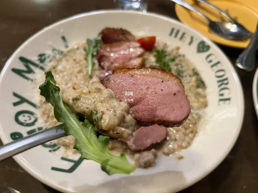 A bite combining smoked duck steak with barley risotto