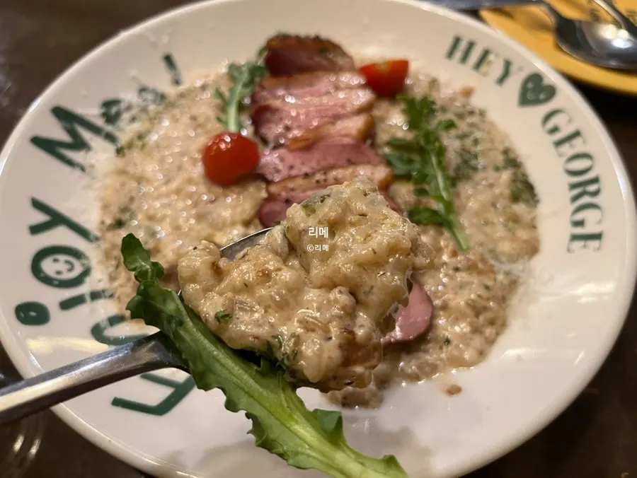 Partially eaten plate of Hey Joji's duck steak risotto