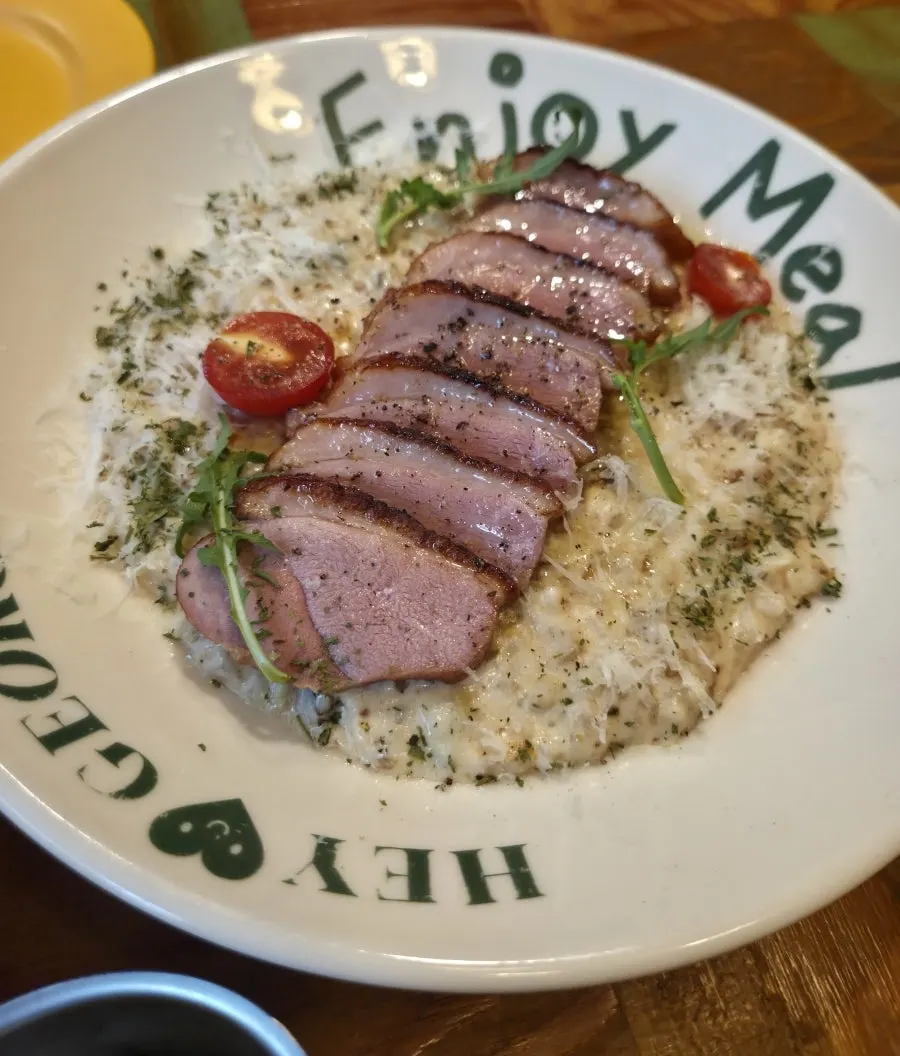 A plate of Hey Joji's duck steak cream risotto