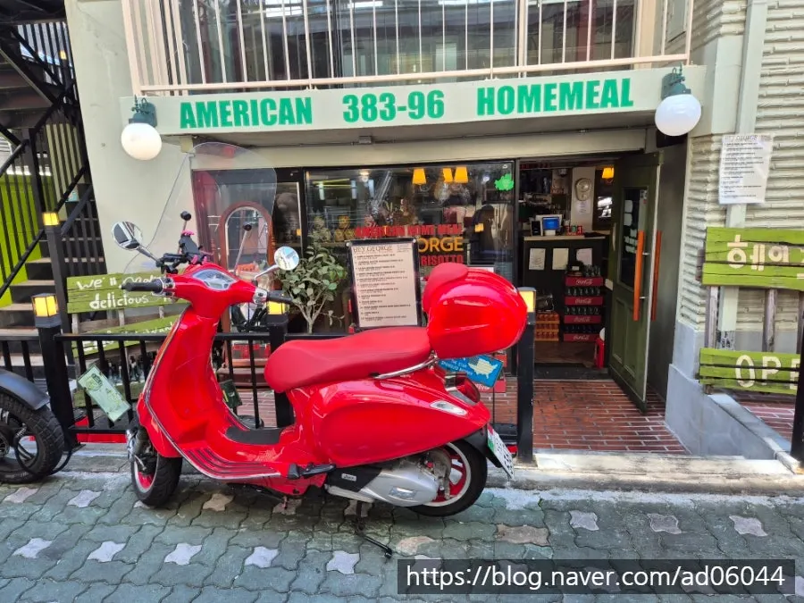 Red scooter parked in front of Hey Joji's entrance