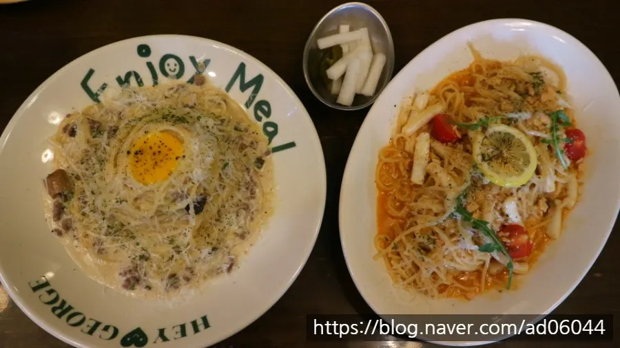 Two plates of pasta set on the table