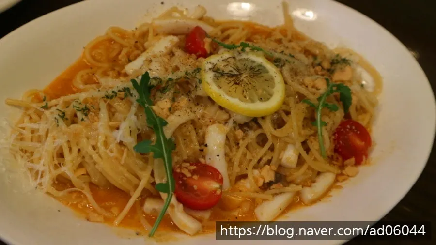 Pasta plated in a bowl decorated with lettering