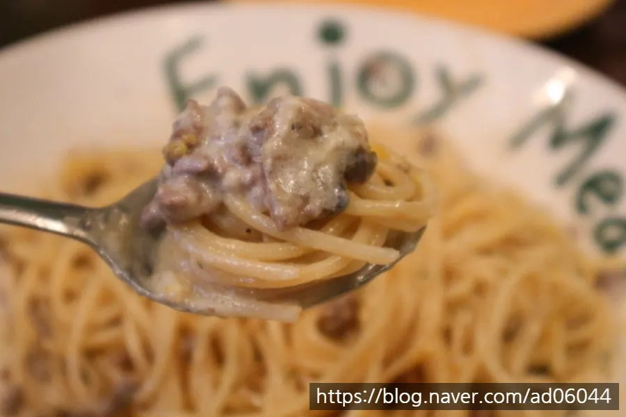 White ragù truffle cream pasta topped with egg yolk