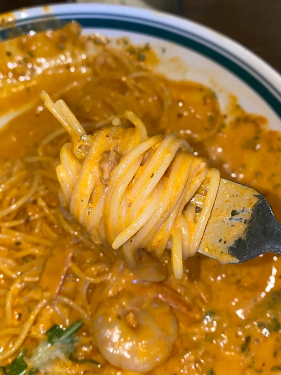 A bite of rosé pasta well-coated in sauce
