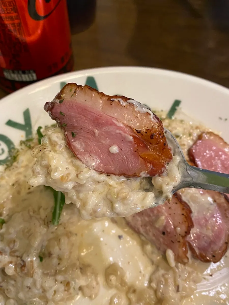 Tender, well-cooked duck meat on top of the risotto