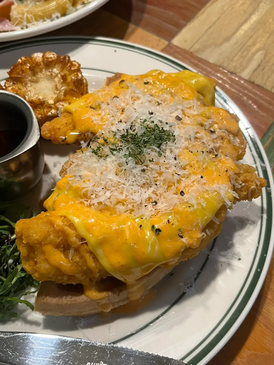 Large pieces of chicken on top of the waffle