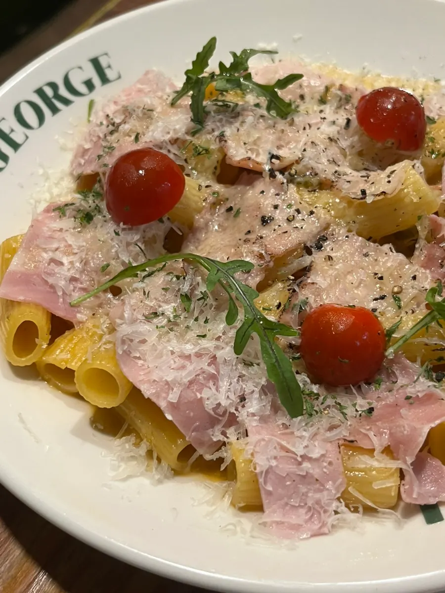 A plate of pasta finished with arugula