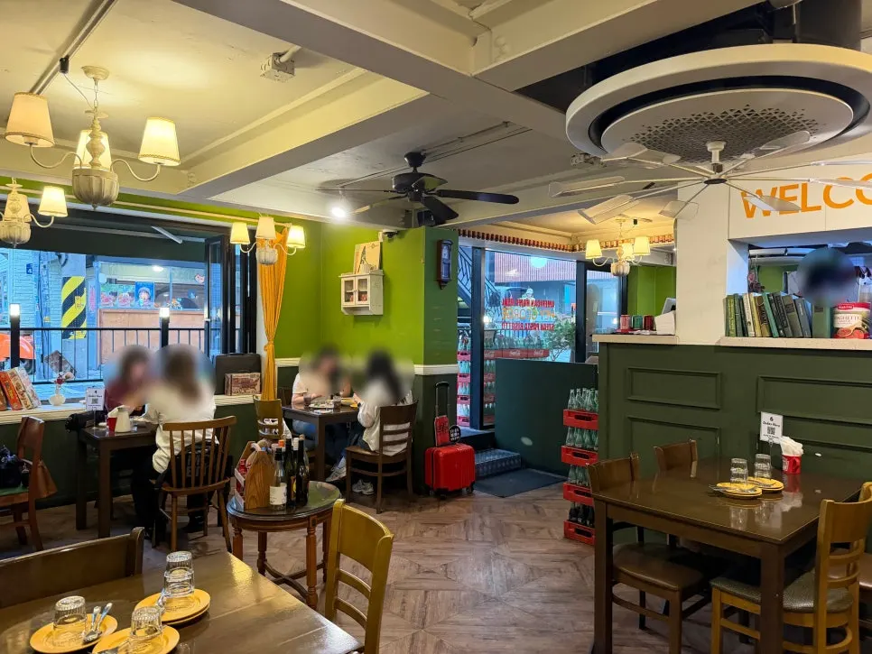 Hey Joji's hall interior with green walls and antique lighting