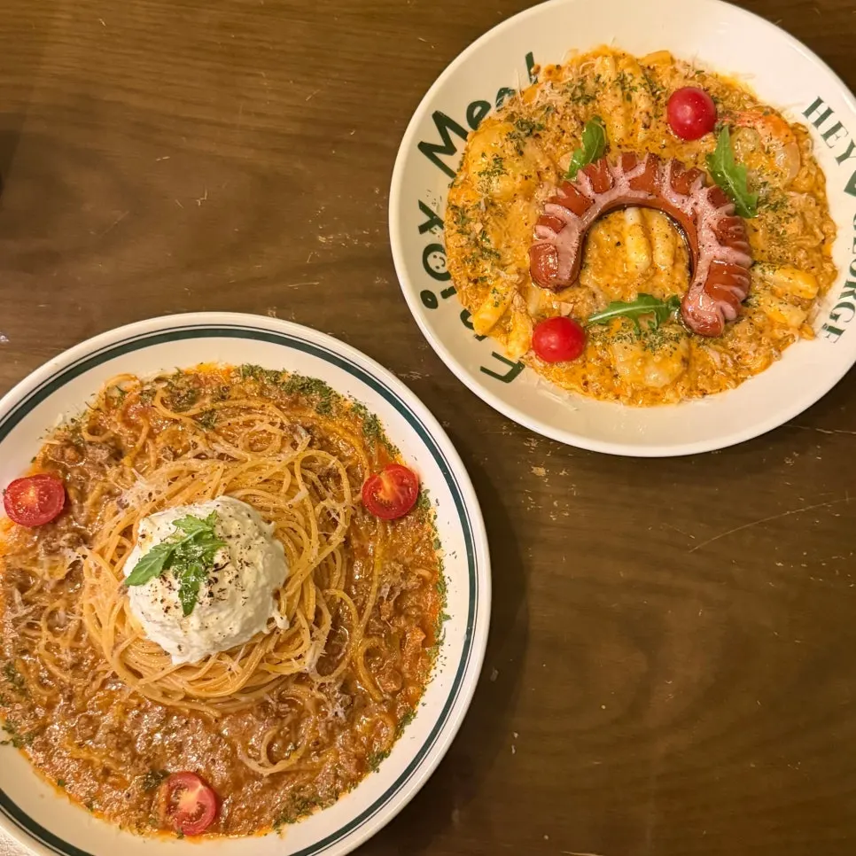 Tomato pasta and jambalaya rosé risotto placed side by side