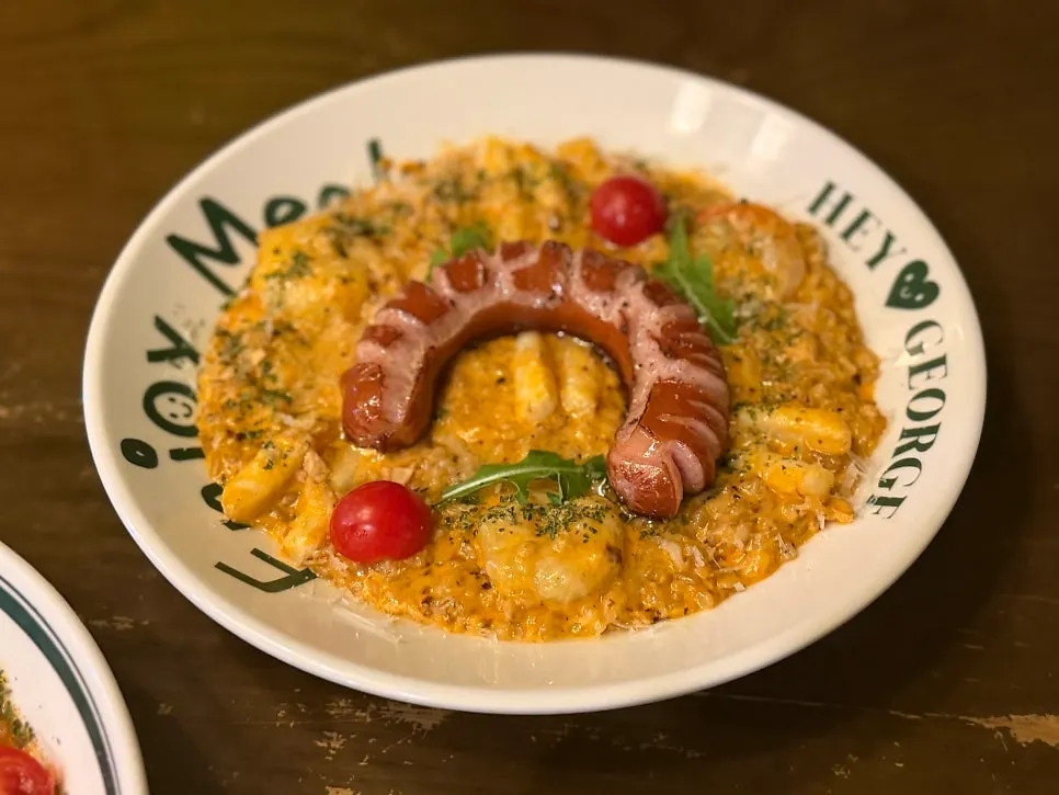 Rosé risotto topped with cherry tomatoes and arugula