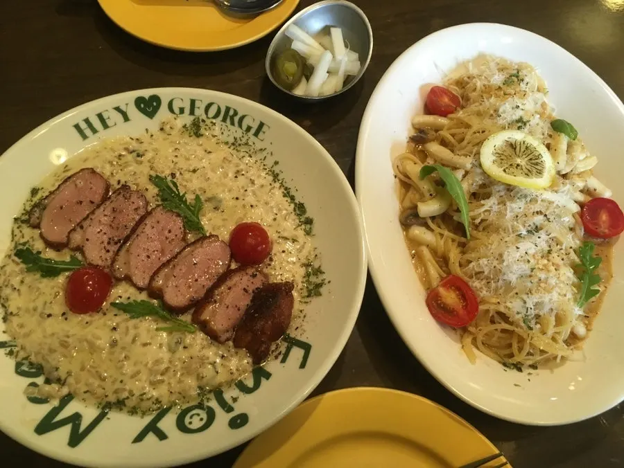 Two plates set out: oil pasta and cream risotto