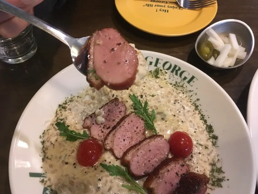 Duck cream risotto plate served with tomato