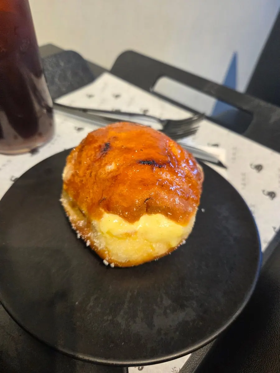 A bite taken out of Heuksadang's cream donut