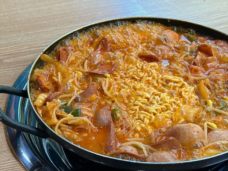 Chewy, well-cooked ramen noodles lifted out of the pot