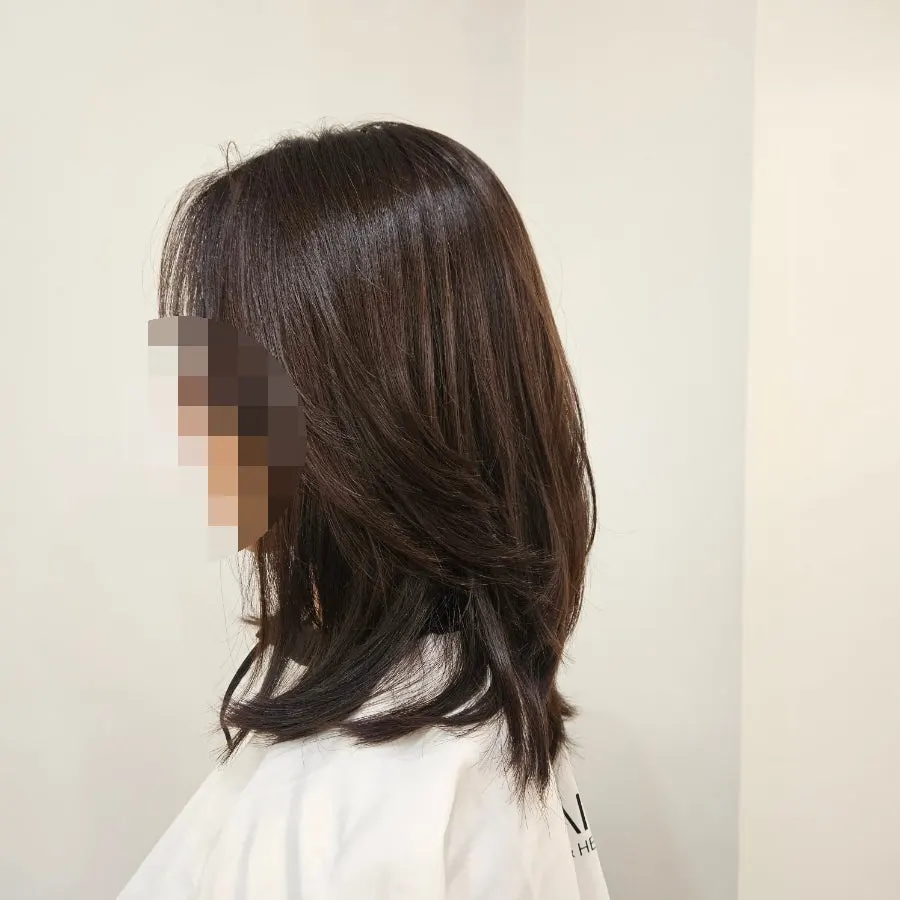 Natural curl falling from leftover perm