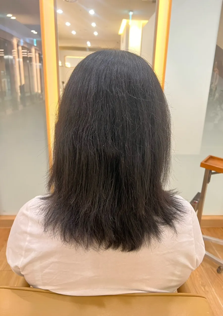Before shot of puffy wavy hair from the back