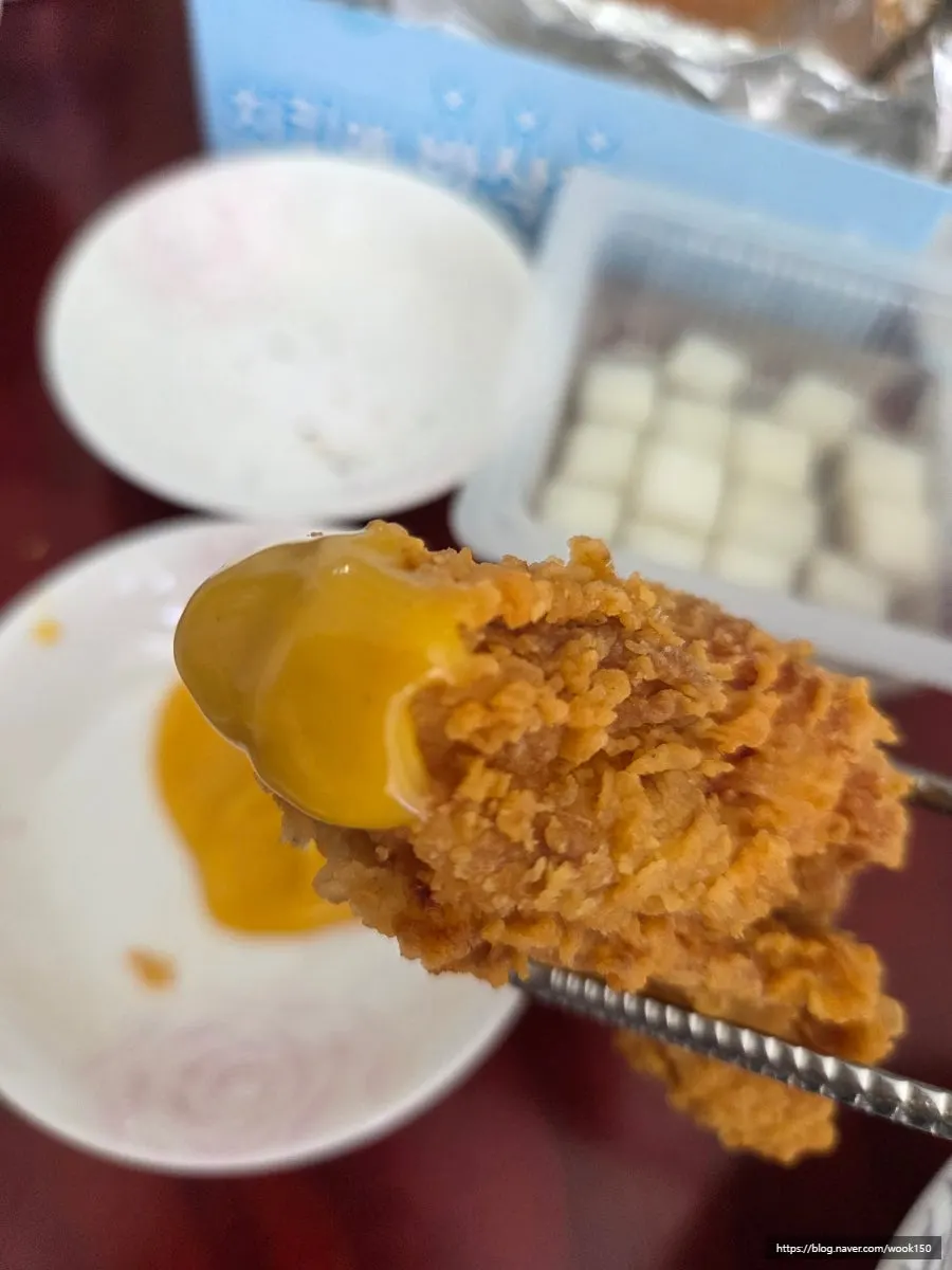 A fried chicken drumstick held up