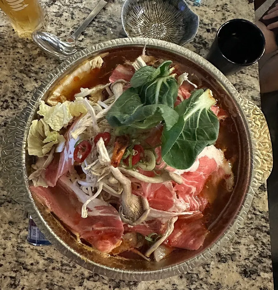 Meat and vegetables inside the Sichuan mala hot pot