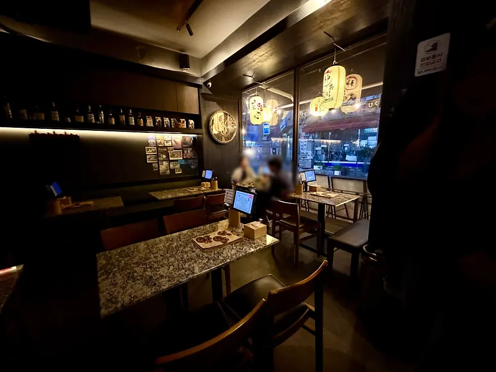 Dimly lit main seating area at Hiku