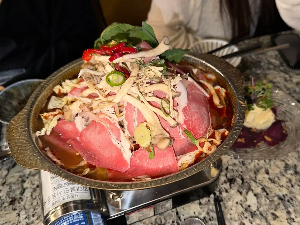 Hiku's Sichuan beef brisket mala hot pot piled with brisket