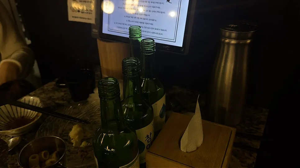 Empty bottles of Chamisul soju finished alongside the hot pot