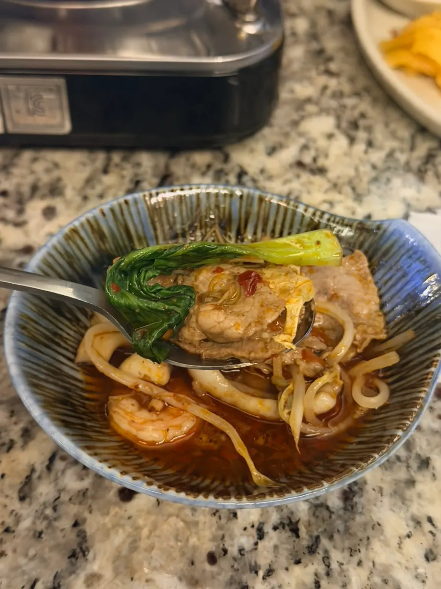 A bowl of mala hot pot served with broth
