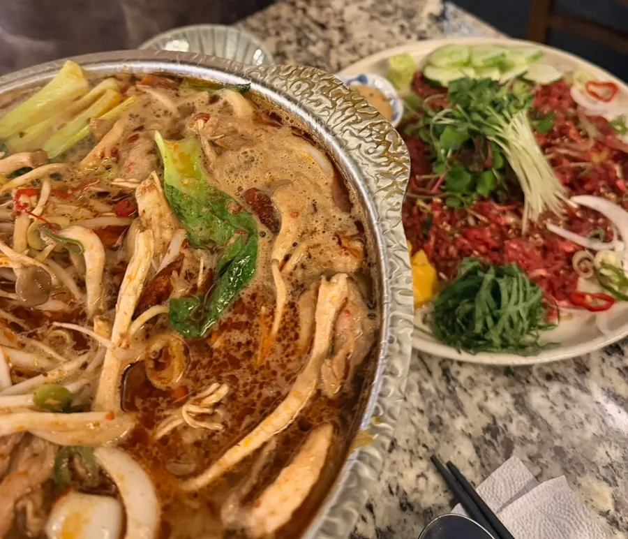 Mala hot pot and beef tartare served together at Hiku