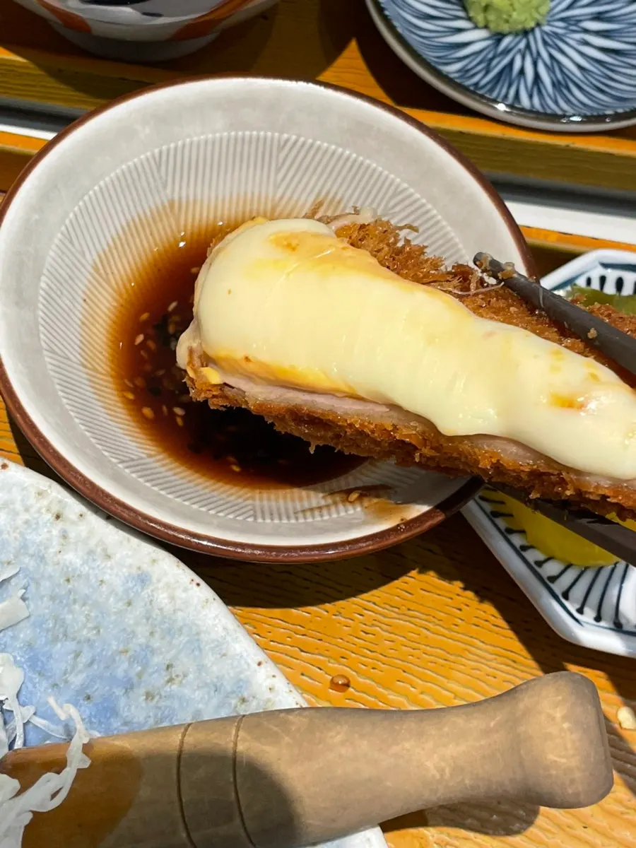 Pieces of cheese katsu lined up on a plate
