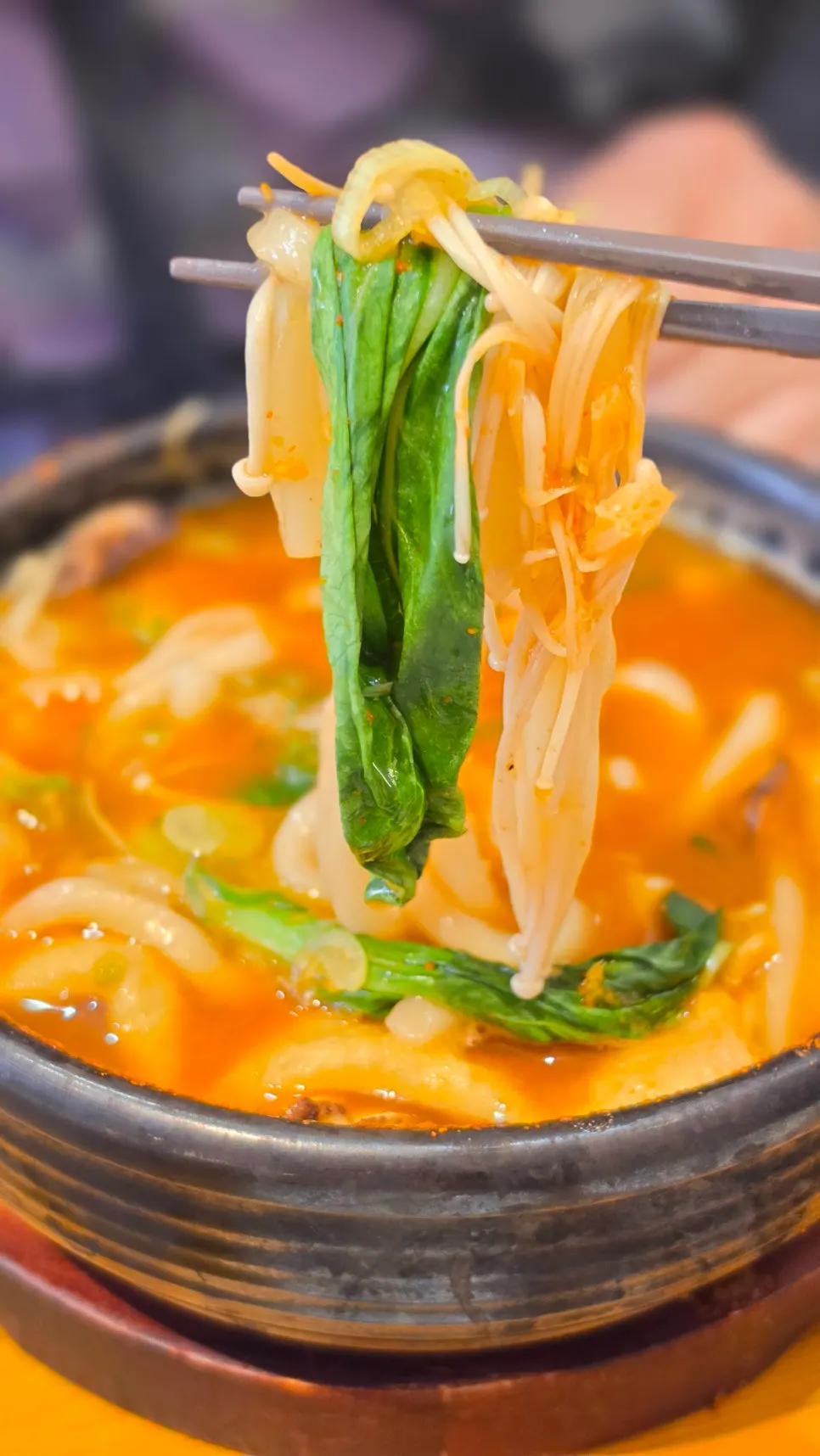 Red, deep broth of the spicy seafood udon