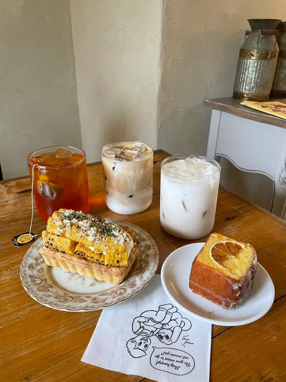 Three iced drinks and two dessert plates
