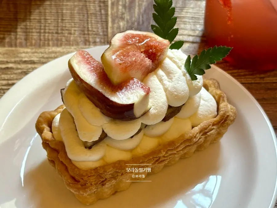 Side view of Hippy's cream pie topped with one fig