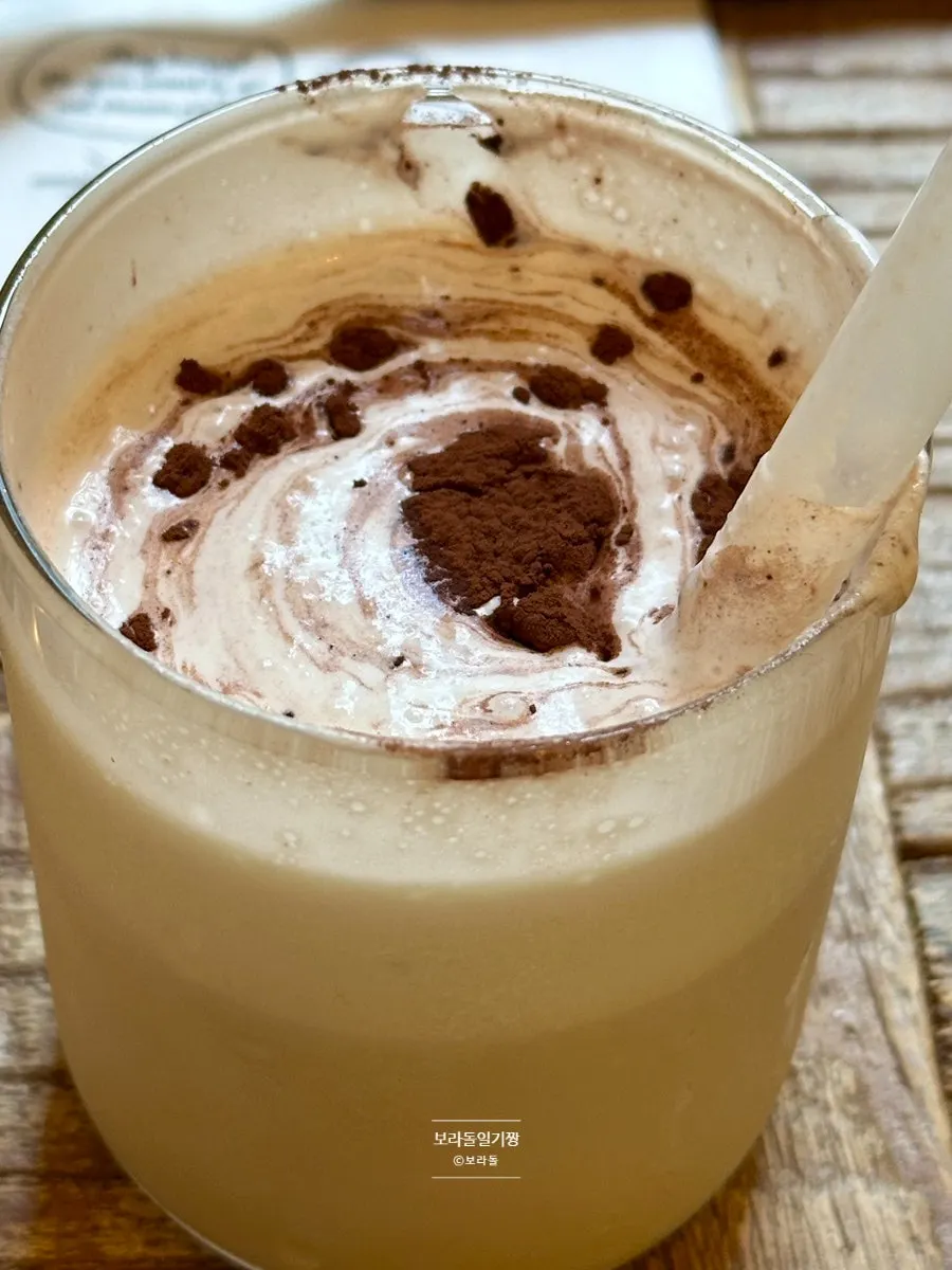 Close-up of the Hippy latte being stirred with a straw