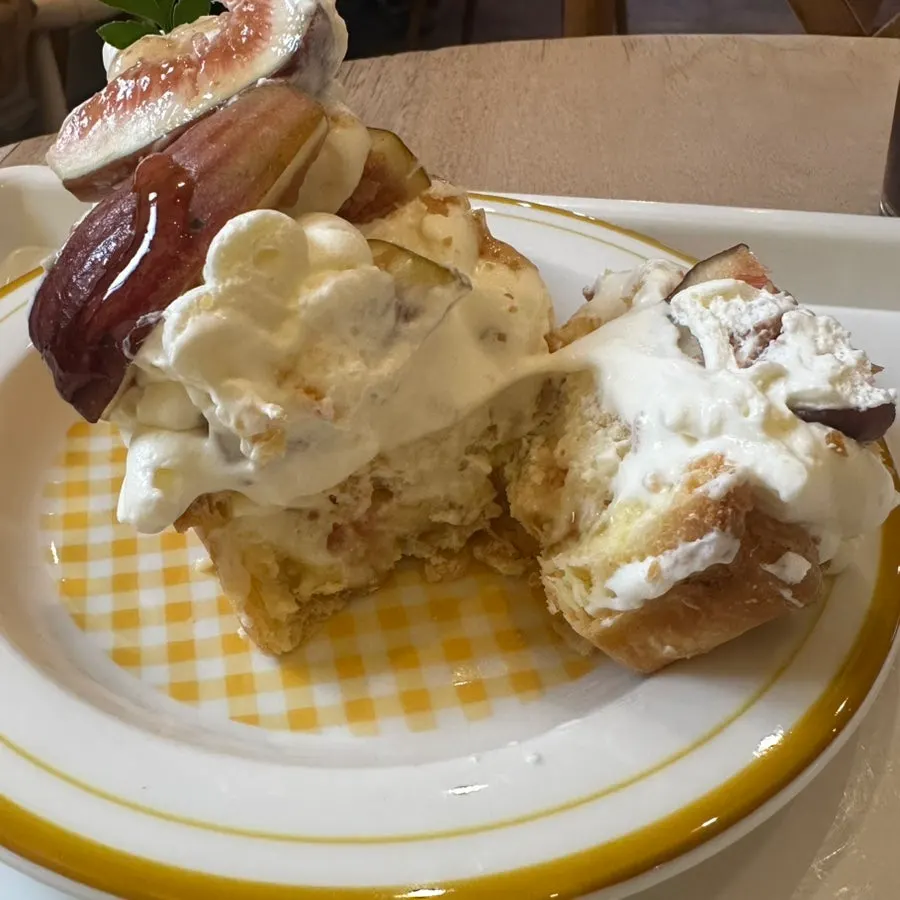 Cross-section of the fig cream pudding pie topped with lots of cream