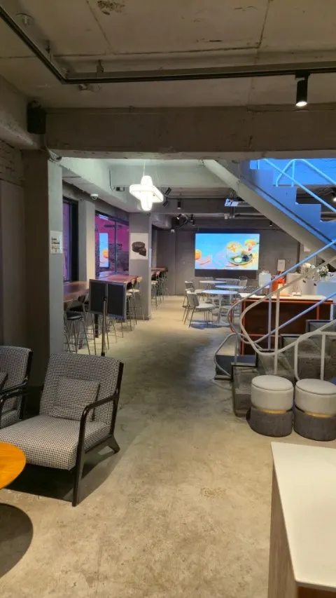 Spacious tables on the 2nd floor of HYBE Playground