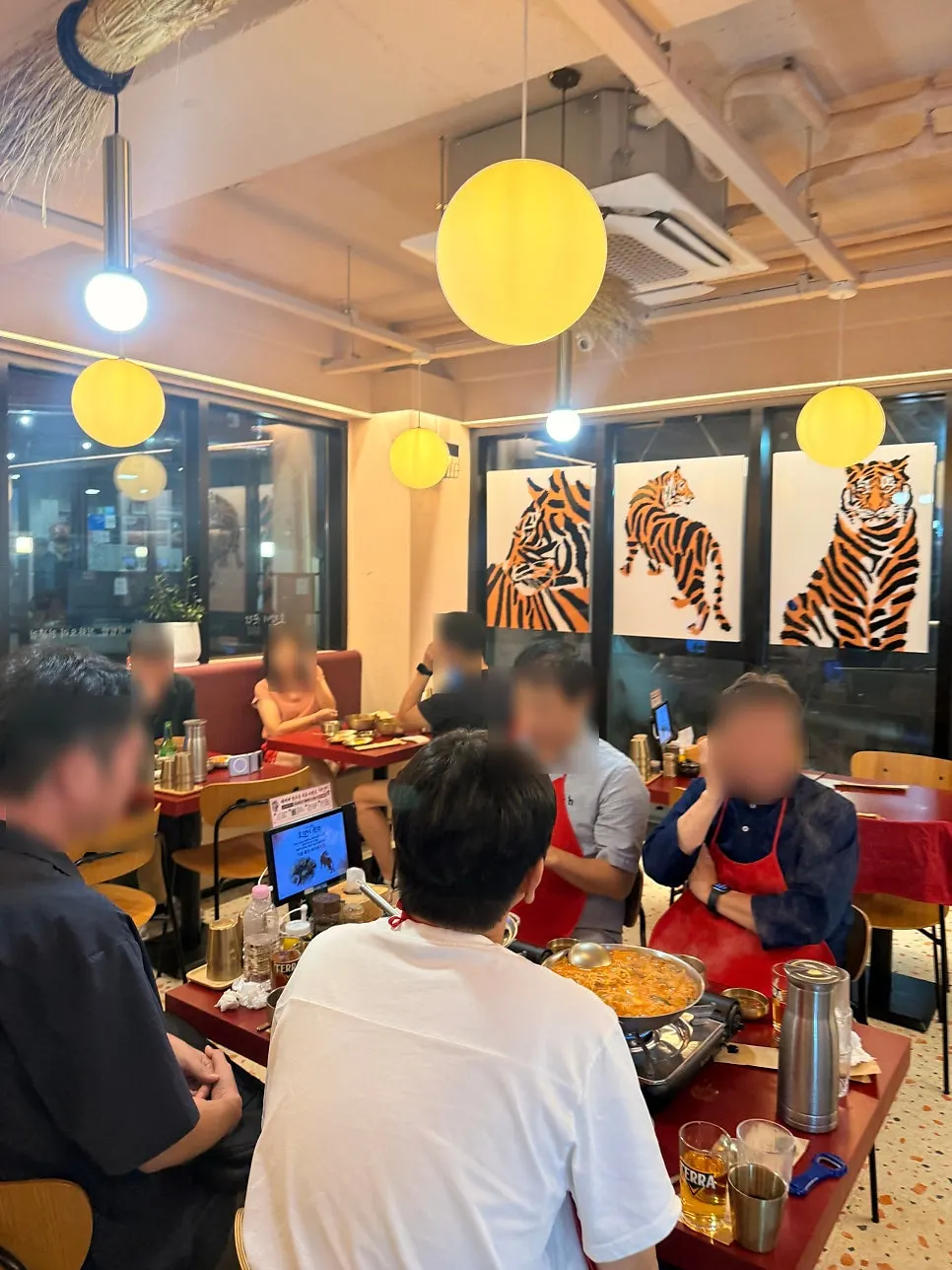 Seating with wood-tone chairs and red tables