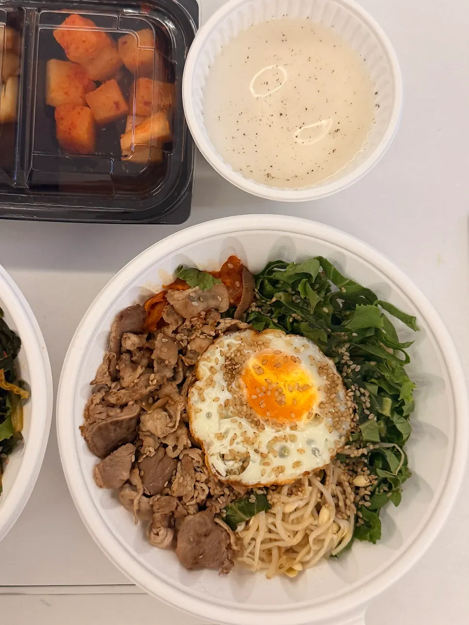 Takeout bibimbap with vegetables and fried egg