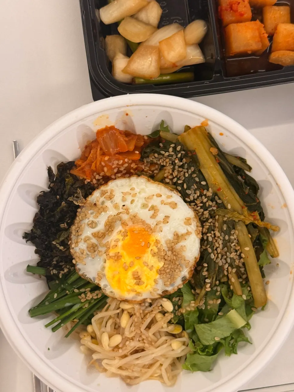 Yeolmu bibimbap topped with young radish greens