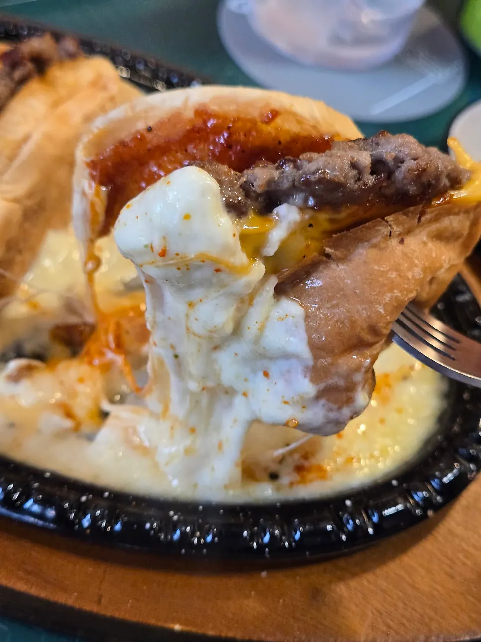 Red Griddle Cheese Burger dipped in melted griddle cheese