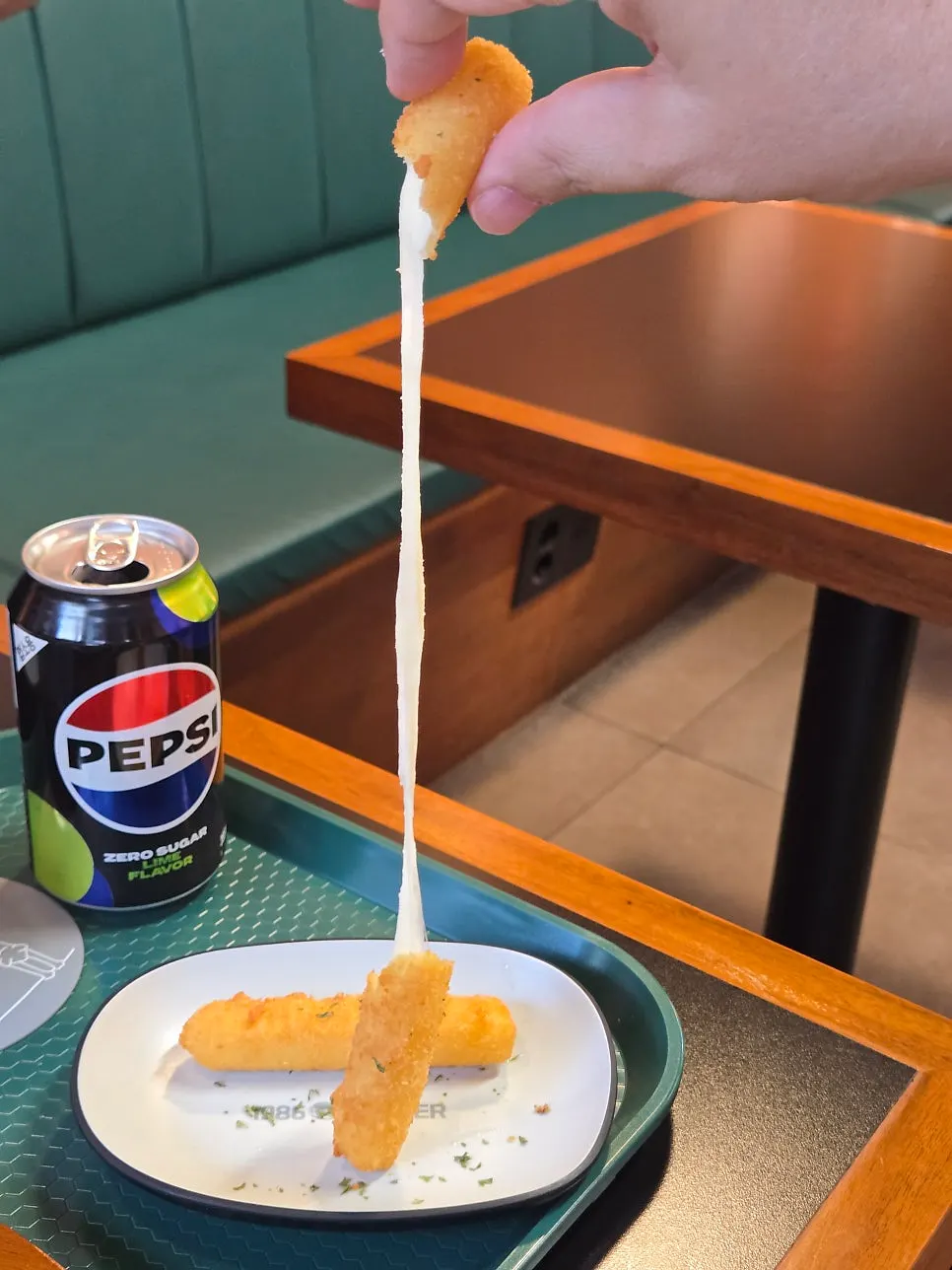 Cheese stick split in half showing the cheese pull