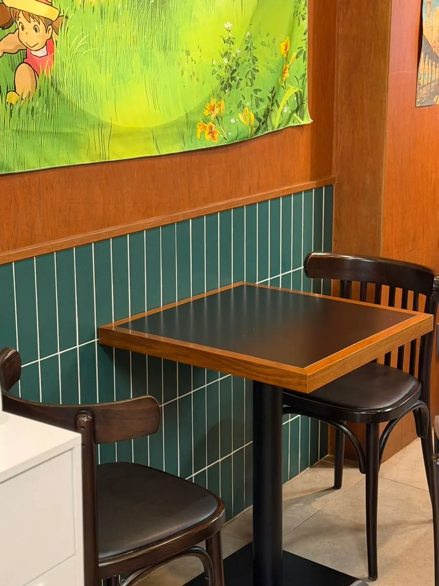 Warmly lit interior seating at 1986 Shibuya Burger