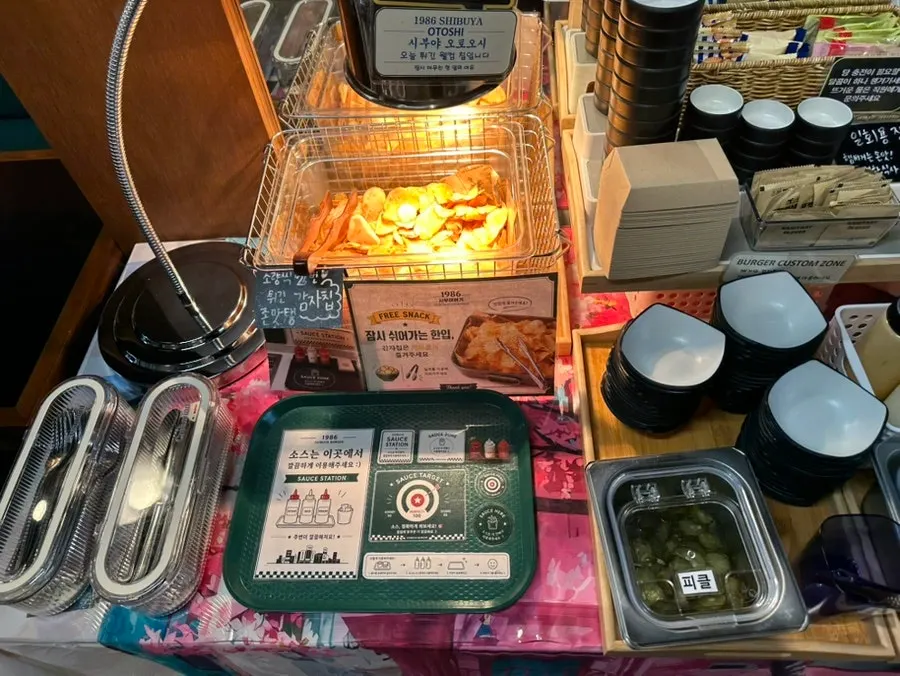 Self-serve bar with pickles and jalapeños